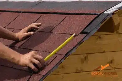 Roofer measuring a roof of asphalt shingles - Norcal-Roofing